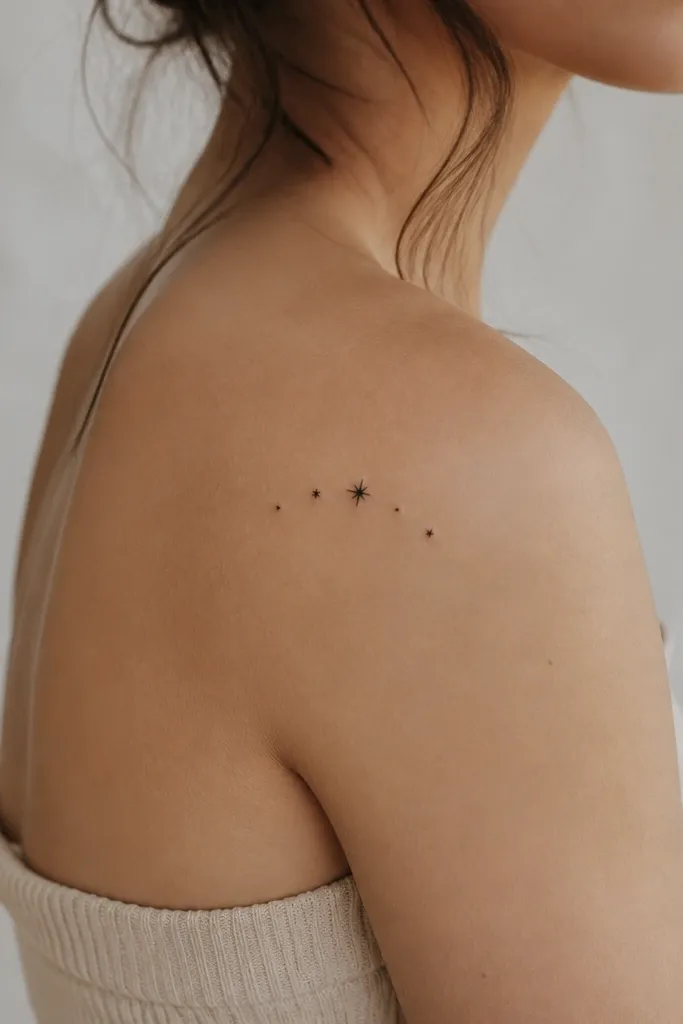 A cluster of five tiny star dots arranged in a loose arc, with one slightly larger star in the center. All elements are black and simple.
