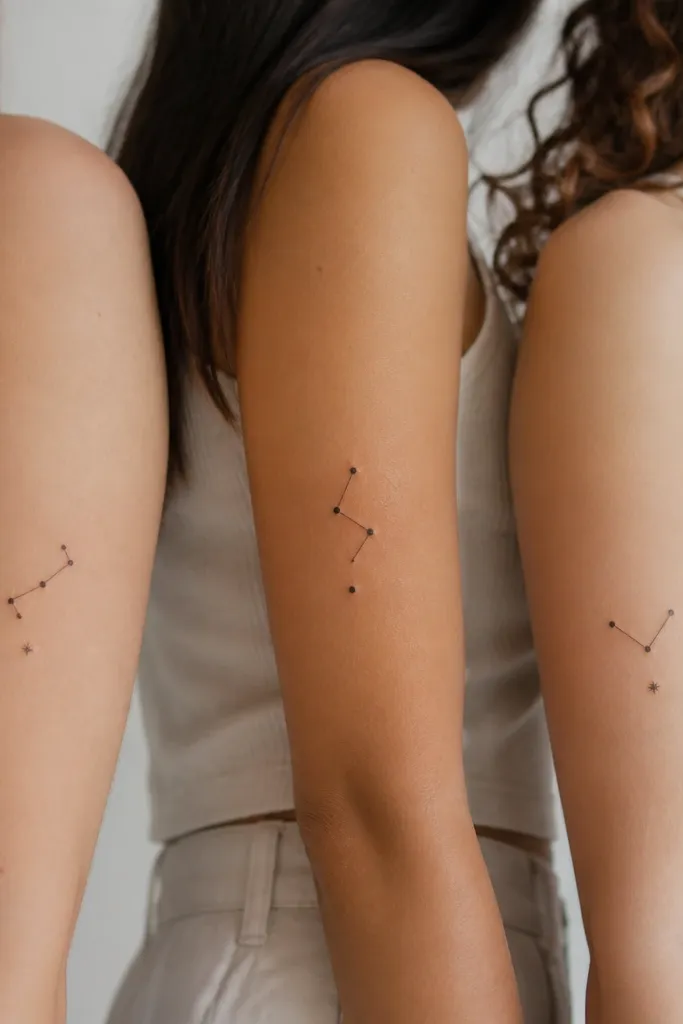 Each tattoo is a compact constellation made of 5 small dots connected by thin lines, forming a different shape. Under the constellation is a single tiny symbol (a dot or a small star) instead of text. Black fine-line ink.