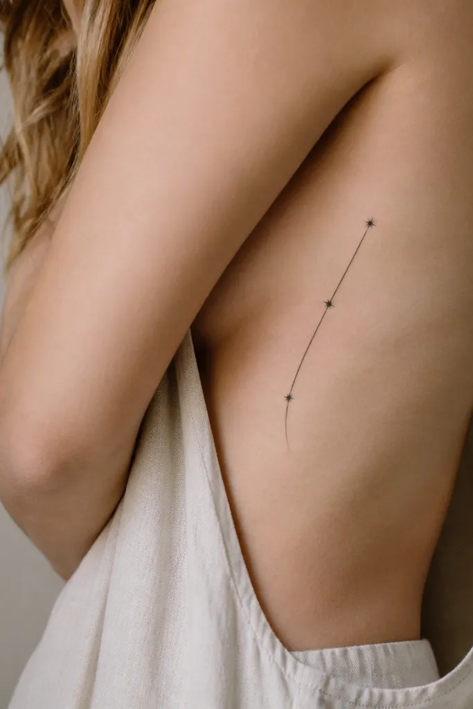 A single thin orbit line curving like an arc with three small star dots spaced along it; black ink on the side ribs.