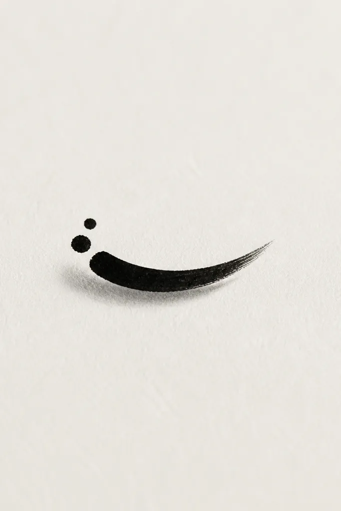 A short brushstroke curve in black with a slight taper, like a calligraphy mark. Two dot accents sit near one end, and there's a faint gray shadow under the curve.