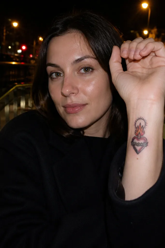 Small heart with outline and subtle blue-red shading, tiny flames, halo ring