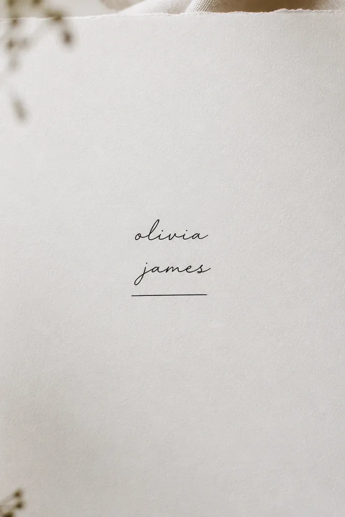 A small name split into two lines, centered, thin black script, with a single straight underline beneath the second line.