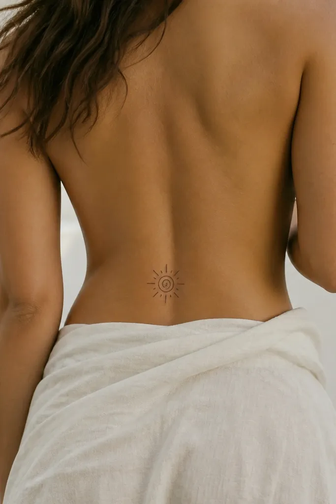 A small spiral centered on the lower back with short spark-like lines radiating outward in black ink.