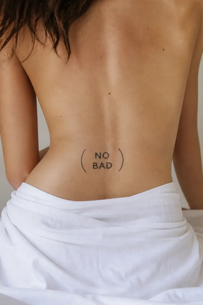 Two short words in black block letters, with a thin curved parenthesis shape drawn around them, centered on the lower back.
